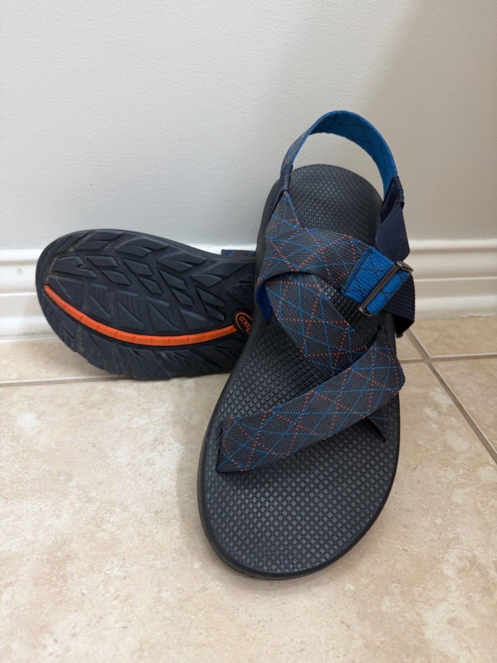 Chaco black sandals with blue and orange-accented webbing